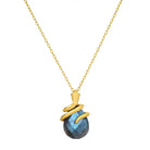 Necklace with a blue labradorite stone pendant with snake and gold chain on a white background