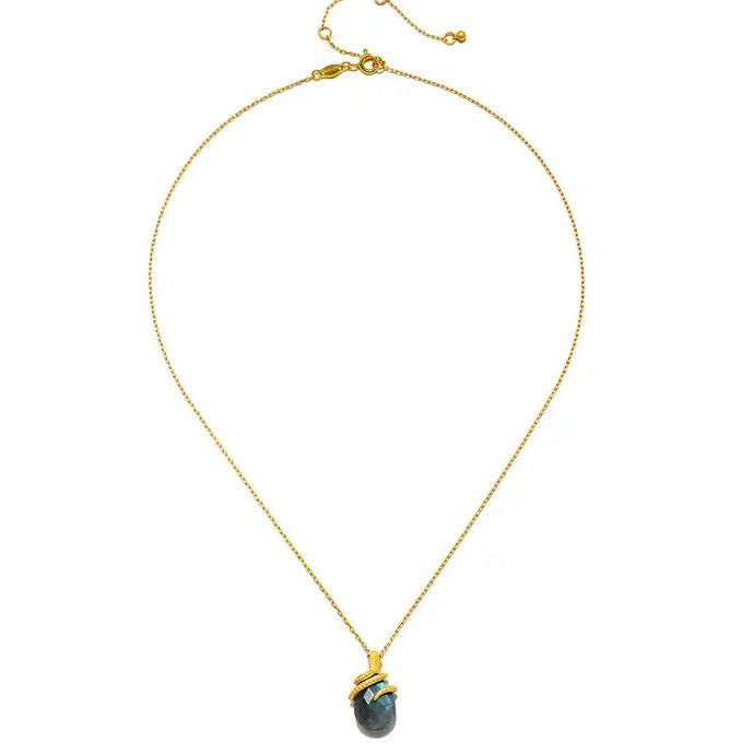 A gold chain necklace with a small gold clasp and extender, featuring a dark iridescent labradorite pendant with snake shown on a plain white background.