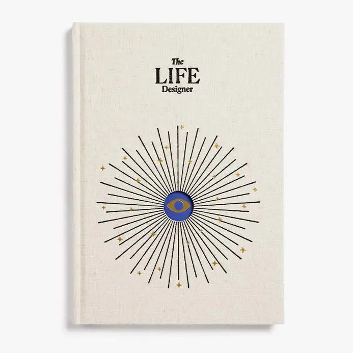Book titled 'The LIFE Designer' with a starburst design on a beige background