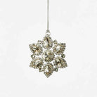 Decorative sparkling snowflake ornament with crystals on a white background