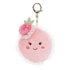 Pink macaron pom-pom keychain with a smiling face and flower on a white background