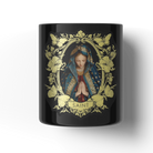 Black candle with a religious design featuring a figure in a floral frame and 'SAINT' text on a white background.