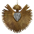 Decorative wall hanging with a heart design and sunburst pattern in gold color.