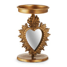 Decorative gold heart-shaped mirror with a candle holder on a white background