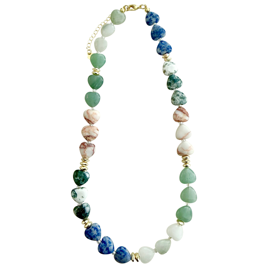 A beaded necklace featuring polished heart-shaped gemstone beads in shades of green, blue, white, and pinkish stone, separated by small gold spacer beads and links, shown on a plain white background.