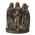 Decorative statue of three figures Mother, Maiden, Crone Goddesses with a cauldron and herbs on a white background