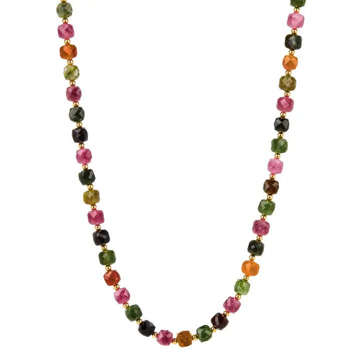 A beaded necklace made of faceted gemstone beads in pink, green, orange, and black tourmaline, separated by small gold spacer beads, shown on a plain white background.