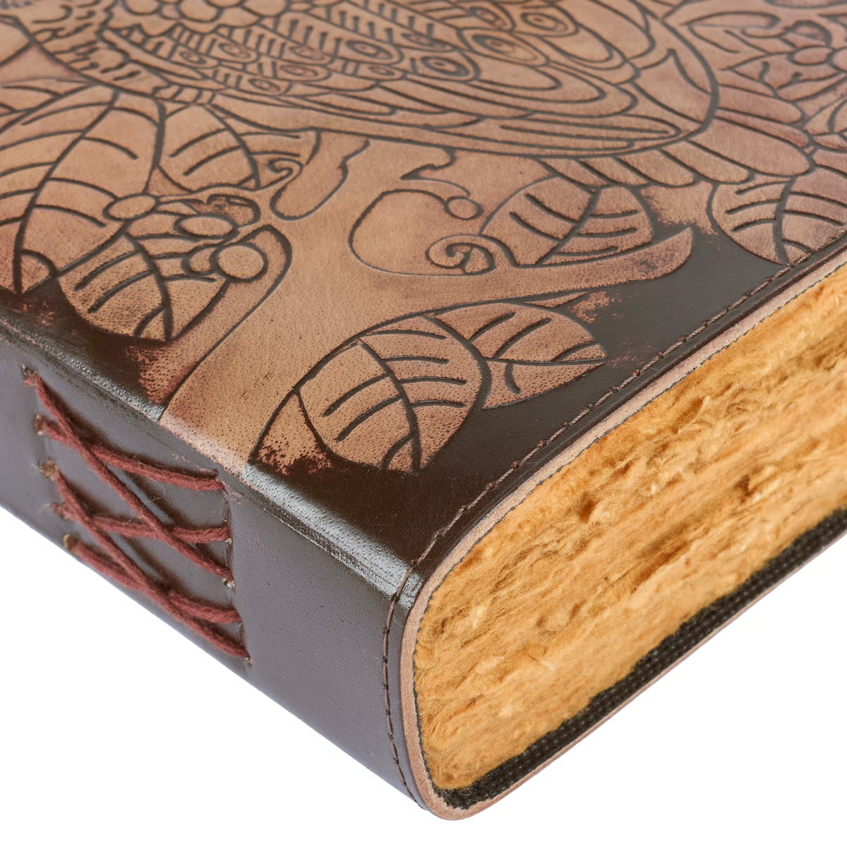 Close-up of a leather-bound book with embossed design and stitching detail.