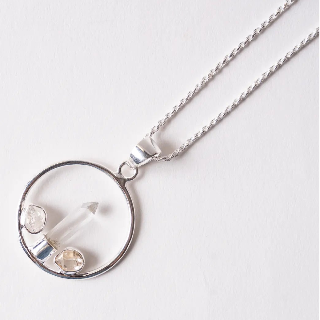 herkimer diamond and quartz Silver necklace with a circular pendant on a white background
