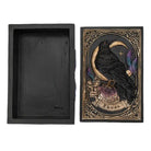 Decorative box with a black raven design on a white background