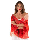 Woman wearing a red floral off-shoulder top on a white background