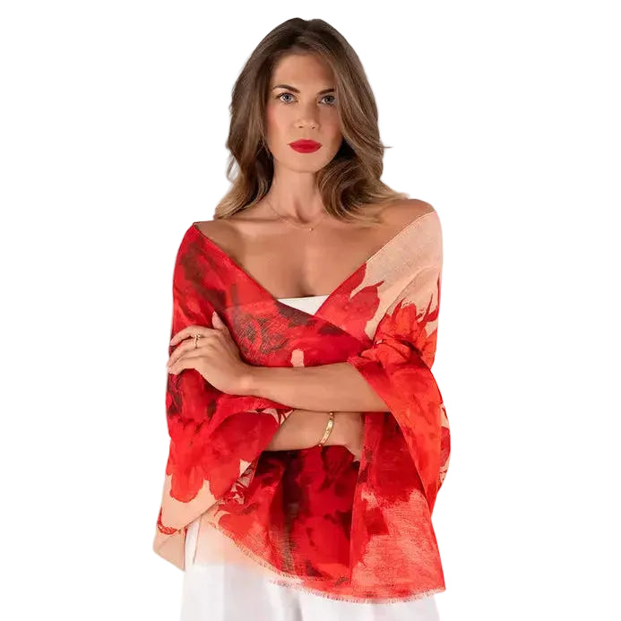 Woman wearing a red floral off-shoulder top on a white background
