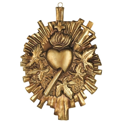 Decorative gold emblem with heart and cross design on a white background
