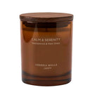 An amber glass jar candle with a dark wood lid, labeled 'CALM & SERENITY' and 'CERERIA MOLLA 1899™', on a plain white background.