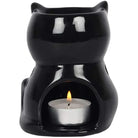 Black cat-shaped essential oil warmer with a lit tealight candle on a white background