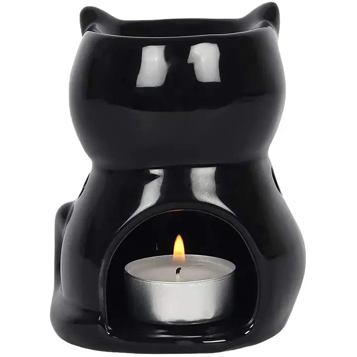 Black cat-shaped essential oil warmer with a lit tealight candle on a white background