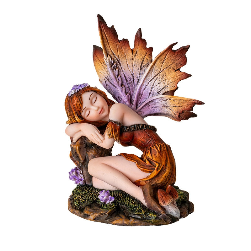 Fairy figurine with leaf wings and purple hair accessory on a white background