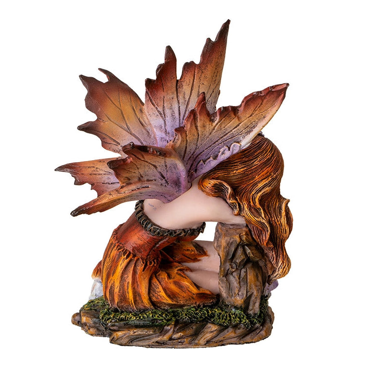 Fairy figurine with leaf-like wings on a white background