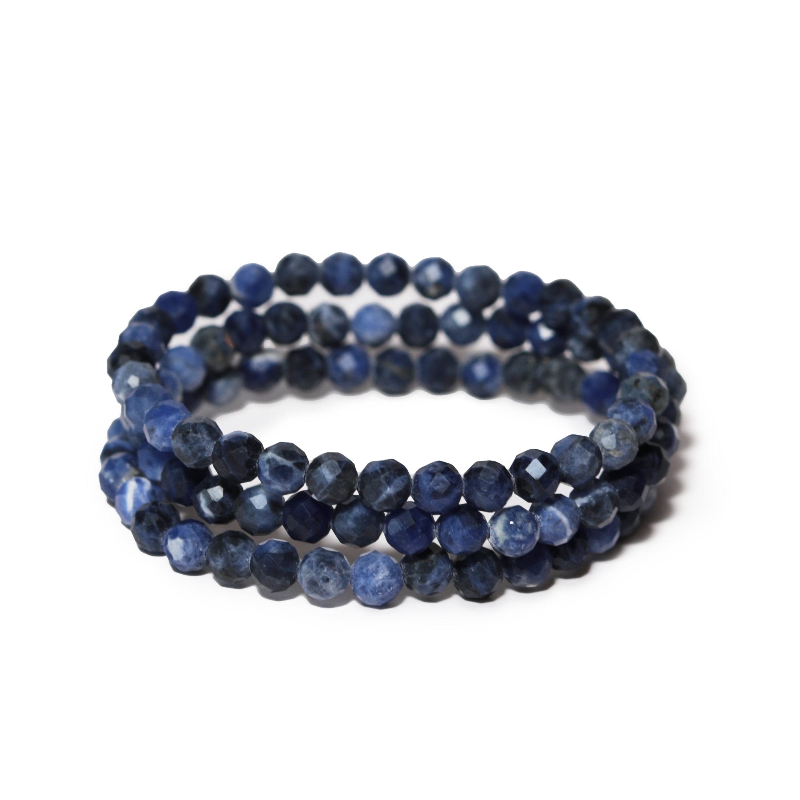 Stack of blue sodalite beaded bracelets on a white background