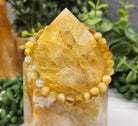 Tiger Eye Honey Smooth Bead Stretch Bracelet on stone view