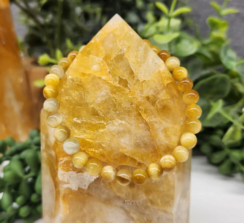 Tiger Eye Honey Smooth Bead Stretch Bracelet on stone view
