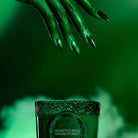 Bewitching Banyan Forest Boxed 8.5oz Candle (Wicked Collection) with a witch hand