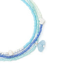 Set of blue aquamarine and white beaded bracelets on a white background