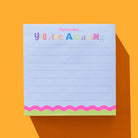 Notepad with 'You Are Amazing' text on a bright orange background
