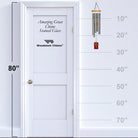Woodstock Chimes Amazing Grace Chime Stained Glass against a white door with measurement scale