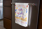 Towel with zodiac design hanging on a refrigerator handle