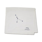 Folded white towel with a black constellation design and text on a white background