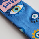 Pack of blue socks with monster design on a light gray background