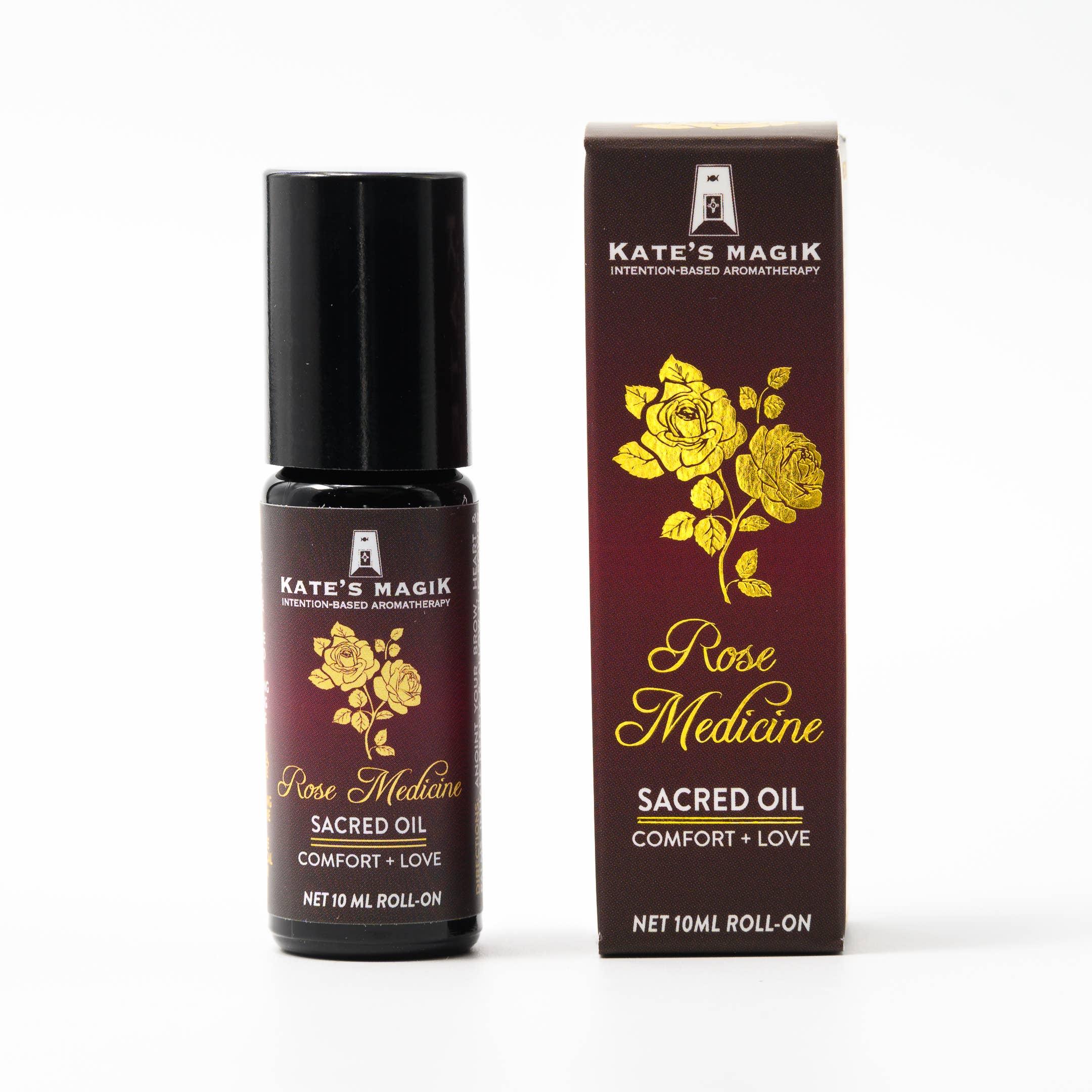 A roll-on bottle of Rose Medicine Sacred Essential Oil Perfume with its packaging box, both featuring a gold and dark background with floral designs.