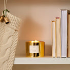 Frasier Fir Gold 3-Wick Candle on a bookshelf