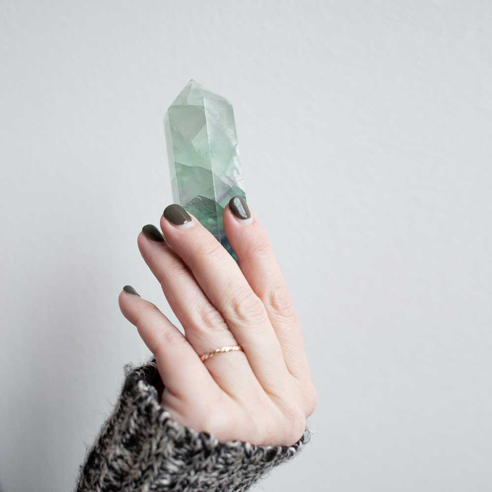 hand holding a lucky fluorite crystal