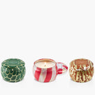 Three decorative candles with different designs on a white background