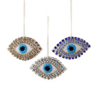 Three decorative evil eye ornaments with rhinestone embellishments on a white background