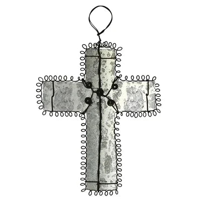 Decorative Milagro Cross with wire wrapping on a white background