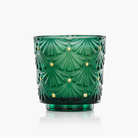 Voluspa Noble Fir Green glass candle with decorative pattern on a white background