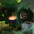 Wicked's Elphaba Palo Santo Spells Mini Tin Candle on Mossy Background