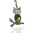 Silver owl pendant with a green moldavite gemstone on a white background