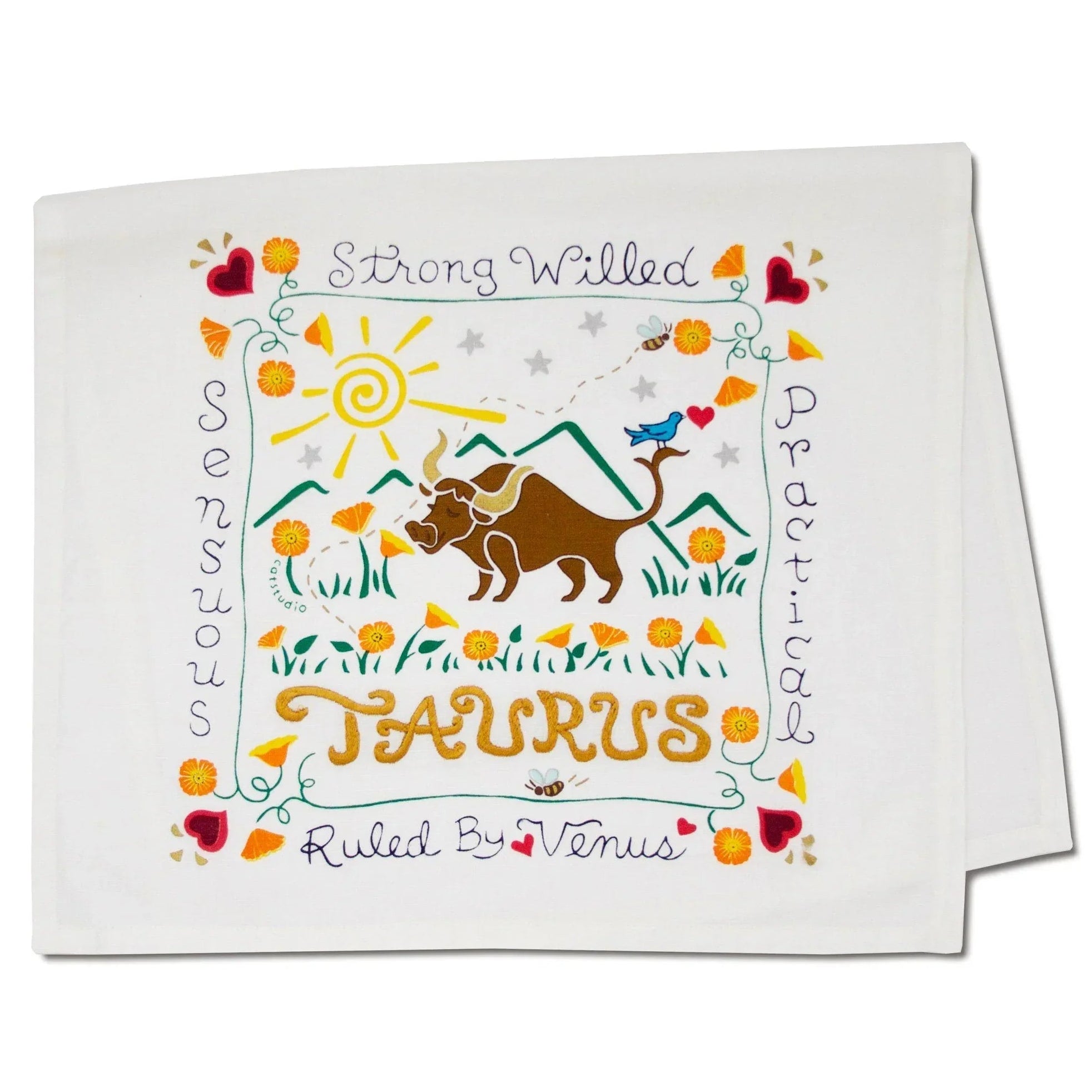 Decorative towel with Taurus zodiac design featuring a bull, sun, and mountains on a white background.