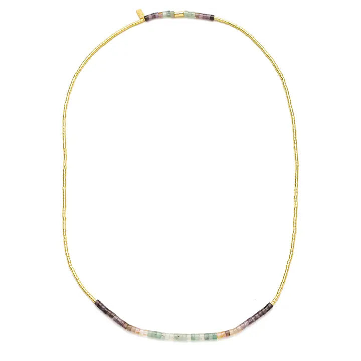 A gold beaded necklace with a curved bar of multicolor gemstone beads at the bottom, displayed on a clean white background.