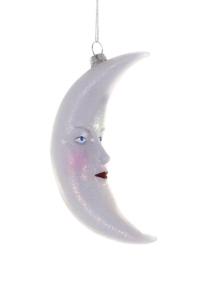 Decorative moon ornament with a face on a white background