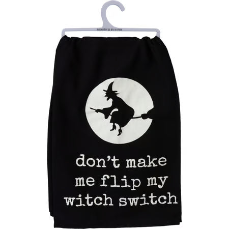 A black pet sweatshirt hanging on a white plastic hanger, featuring a white circular graphic of a witch riding a broomstick and the text 'don't make me flip my witch switch' in white lowercase letters.