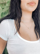 Young Woman With Dark Hair Wearing Pharauh's Evil Eye Necklace